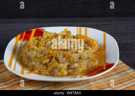 Stewed cabbage with carrot and onion on the plate Stock Photo