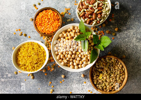 Healthy food, dieting, nutrition concept, vegan protein source. Raw of legumes (chickpeas, red lentils, canadian lentils, beans, bulgur, chickpea). To Stock Photo