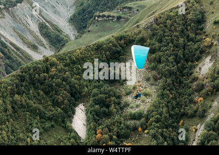 paraglider fly over mountain on a sunny day. Paragliding in the Caucasus Mountains Stock Photo