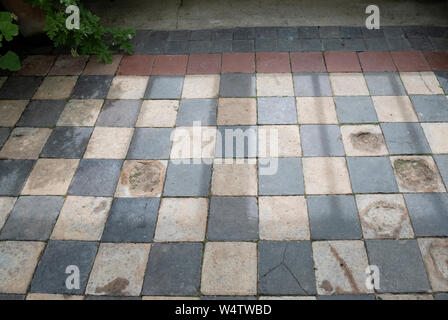 Old black and white check tile stone floor Stock Photo