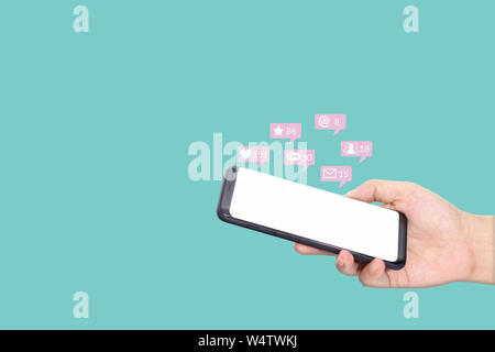 people using mobile smartphone with blank white screen for social media interactions with notification icons from friend in social network with like, Stock Photo