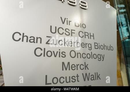 Close-up of sign outside the Chan Zuckerberg Biohub, a life sciences research center sponsored by Facebook founder Mark Zuckerberg, in the Mission Bay neighborhood of San Francisco, California, with logos for Vir Bio, UCSF, Clovis Oncology, Merck and Locust Walk also visible, November 13, 2018. () Stock Photo