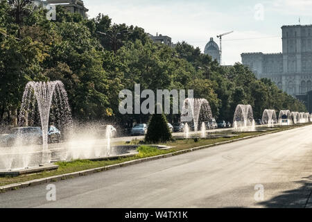 Fountains on Unirii Boulevard, Bucharest, Romania (Bulevardul Unirii). It runs from Piața Unirii (Unification Square) to the Palace of the Parliament Stock Photo