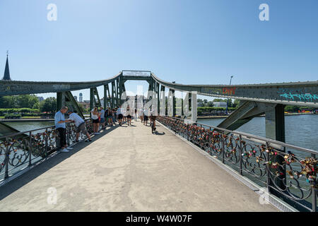 Frankfurt am Main, July 2019. A view of the people walk  on the Iron Bridge Stock Photo
