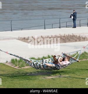 warsaw, Poland. May, 2019. a couple lying on a hammock on the bank of the Vistula River Stock Photo