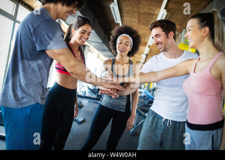 Happy gorup of healthy people training in gym Stock Photo