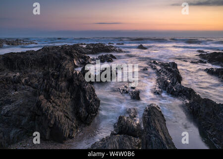 Croyde Bay rocks at seascape at sunset Stock Photo