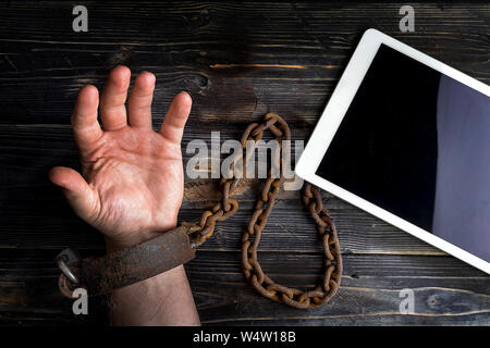 Smart phone addiction concept on red background. Hand is handcuff Stock Photo