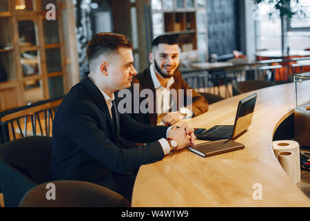 Two businessmen working in a cafe Stock Photo