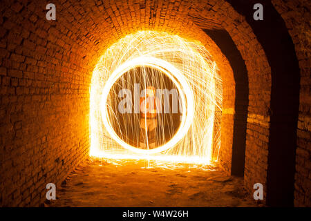 Light painting / light drawing with fire and steel wool underground Stock Photo