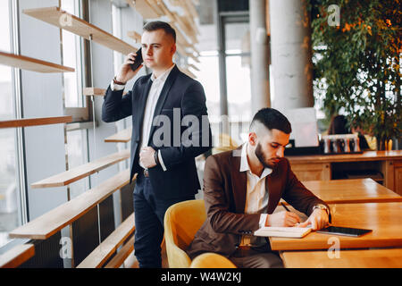 Two businessmen working in a cafe Stock Photo