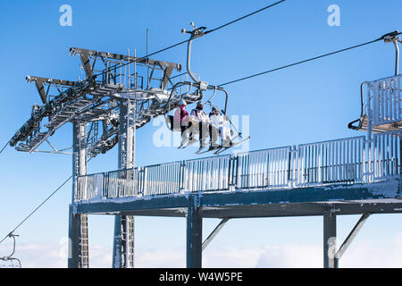 Kopaonik, Serbia - January 22, 2016: Skiers arriving to the station on the ski lift Stock Photo