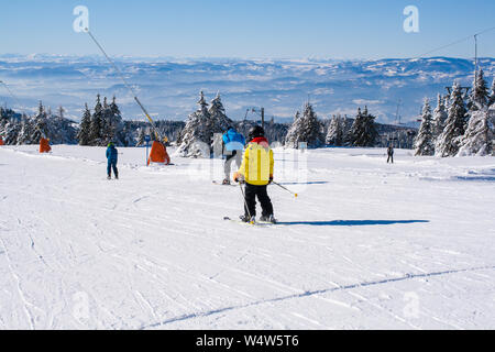 Kopaonik, Serbia - January 20, 2016: Ski resort Kopaonik, Serbia, ski slope, people skiing down the hill, mountains view Stock Photo