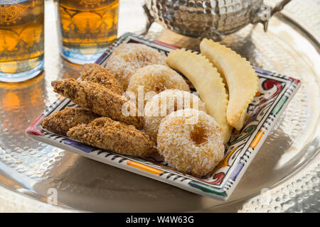 Traditional Moroccan cookies on a dish with tea and teapot Stock Photo