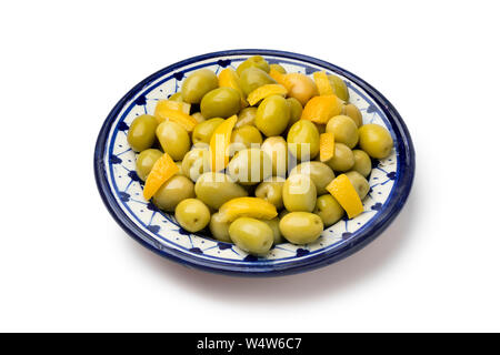 Dish with traditional Moroccan olives and lemon isolated on white background Stock Photo