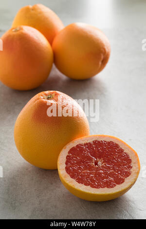 Whole and halved fresh juicy red grapefruit Stock Photo