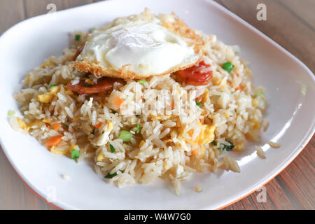 stir-fried rice with deep fried sausage ,egg and vegetable Stock Photo