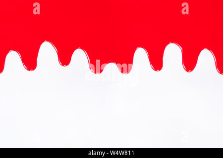 Red paint dripping on a white background Stock Photo