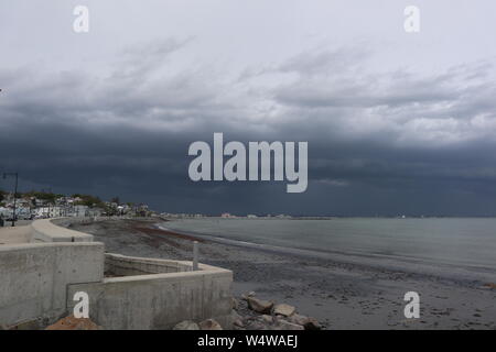 Dark Clouds Rolling Over Beach Stock Photo