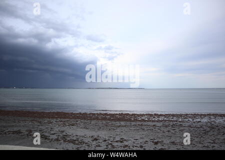 Dark Clouds Rolling Over Beach Stock Photo