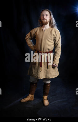 young red-haired viking man in everyday costume of the early Middle Ages, hobby, historical reconstruction Stock Photo
