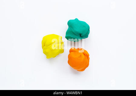 Colorful plasticine clay on white background. Stock Photo