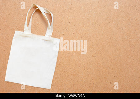 White fabric bag on plywood background.  Copy space Stock Photo