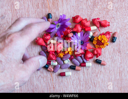 Amoxicillin and Flucloxacillin antibiotics, flowers and herbal pills. Homeopathy, alternative medicine..., concept image Stock Photo