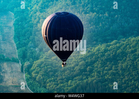 Hot air balloon ride over Tuscany valley Stock Photo