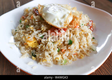 stir-fried rice with deep fried sausage ,egg and vegetable Stock Photo