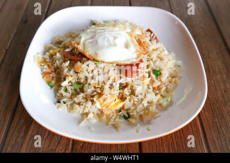 stir-fried rice with deep fried sausage ,egg and vegetable Stock Photo