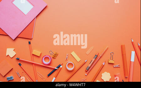 Back to school. School supplies orange color on orange background, top view, copy space Stock Photo