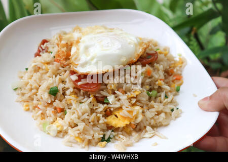 stir-fried rice with deep fried sausage and egg Stock Photo