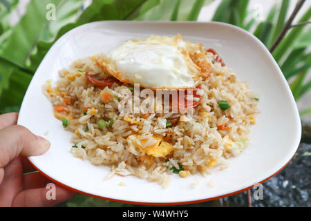 stir-fried rice with deep fried sausage ,egg and vegetable Stock Photo