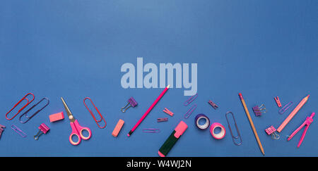 Back to school. School office supplies pink, purple color on blue background, top view, copy space Stock Photo