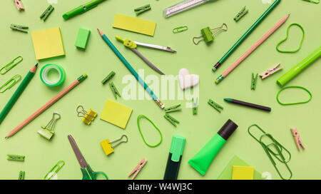 Back to school. School supplies green color on green background, top view Stock Photo