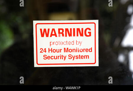 Security sticker on front door of a home. Stock Photo
