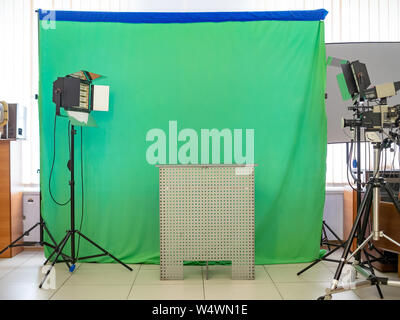 Real empty green screen (Chroma key) film/photo studio with lighting/studio equipment Stock Photo