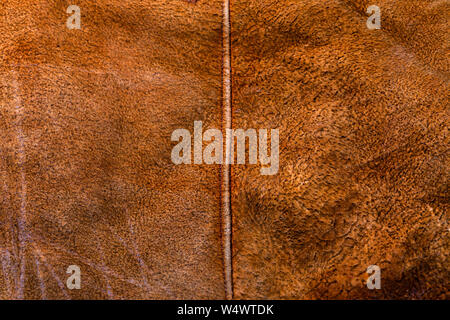 small brown weathered seude jacket closeup texture with selective focus and blur Stock Photo