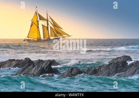 The schooner Anny owned by Rolf Munding under full sail sailing past Fistral in Newquay in Cornwall. Stock Photo