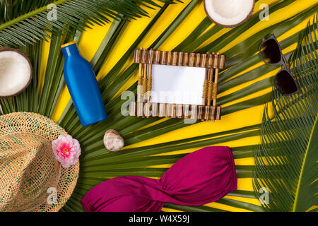 Palm leaf, sunblock, hat, sunglasses and starfish on yellow background with  copy space in the center Stock Photo - Alamy