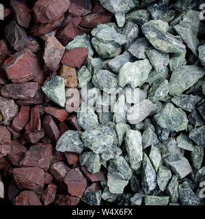 The combination of gray and dark red, natural background, decorative stones, aquarium stones, stones for the garden, landscape design Stock Photo