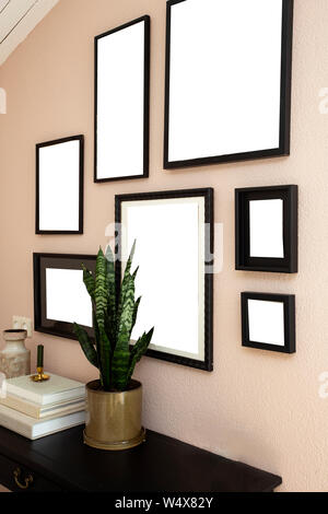 collection of various blank black frames on wall with modern decoration, green plant in a lovely home Stock Photo