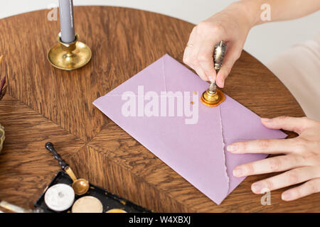 Stamping old notarial wax seal on document. Close up. Selective focus. Stock Photo