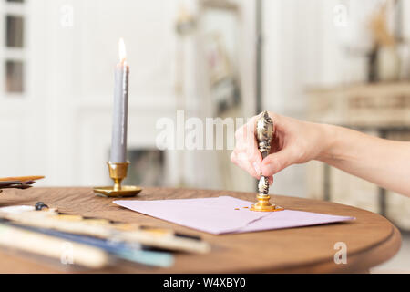 Stamping old notarial wax seal on document. Close up. Selective focus. Stock Photo