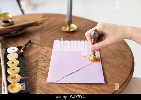 Stamping old notarial wax seal on document. Close up. Selective focus. Stock Photo