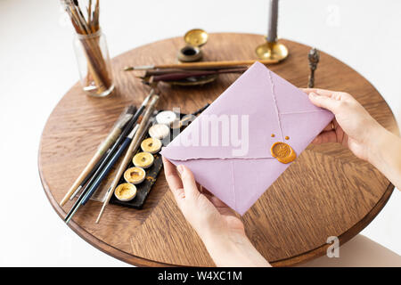 Stamping old notarial wax seal on document. Close up. Selective focus. Stock Photo