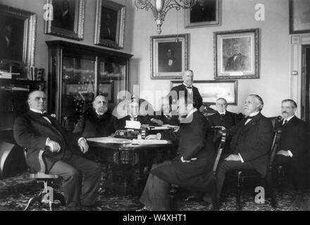 U.S. President William McKinley and his Cabinet, L-R: William McKinley, Secretary of the Treasury Lyman J. Gage, Attorney General John W. Griggs, Secretary of the Navy John D. Long, Secretary of Agriculture James Wilson (standing), Secretary of State John Hay, Secretary of the Interior Cornelius N. Bliss, Secretary of War Russell A. Alger, and Postmaster General Charles E. Smith, Washington, D.C., USA, 1898 Stock Photo