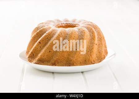 Sweet bundt cake on white table. Stock Photo