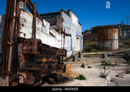 Old historic abandoned cannery building and fish hopper and tank on Cannery Row in Monterey, California Stock Photo